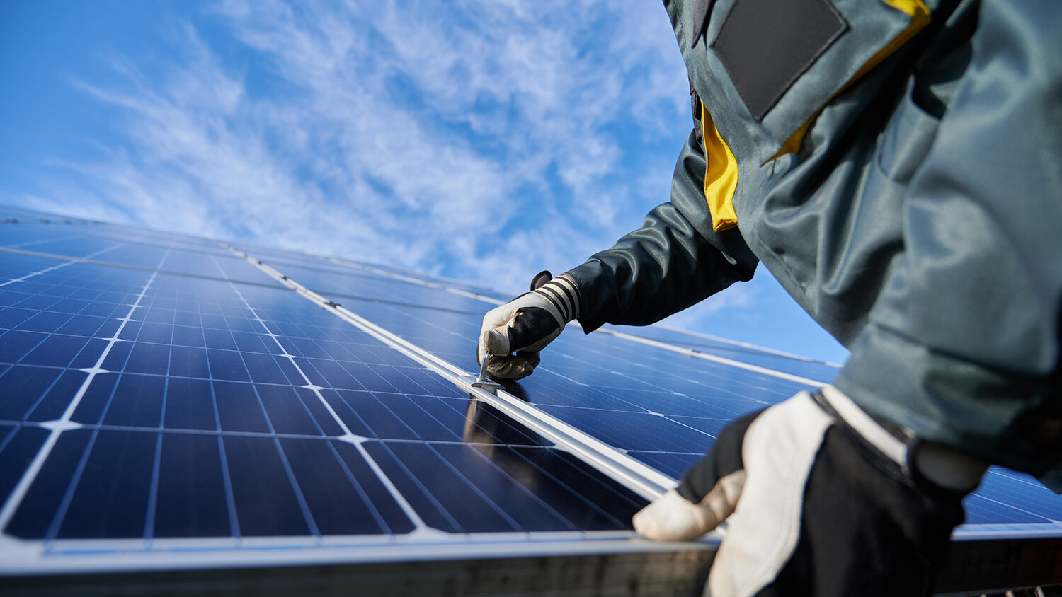 Technicians inspecting rooftop solar panels
